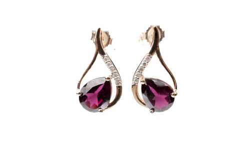 A pair of garnet and diamond earrings in 9 carat yellow gold