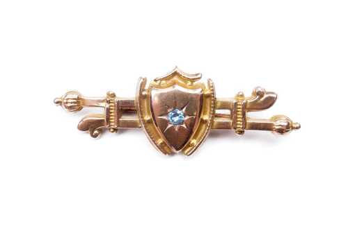 An antique blue topaz bar brooch in 9 carat yellow gold