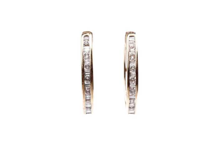 A pair of oval diamond hoops in 9 carat yellow gold