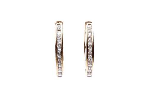 A pair of oval diamond hoops in 9 carat yellow gold