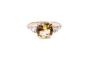 A citrine, white topaz and diamond ring in 9 carat yellow gold