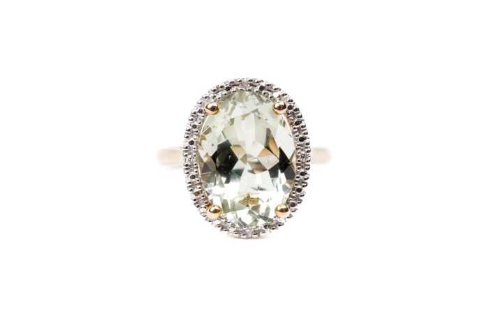 A green amethyst and diamond ring in 9 carat yellow gold