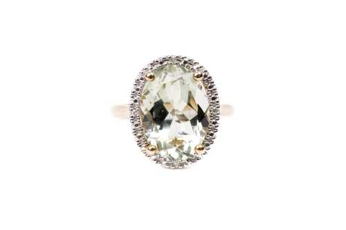 A green amethyst and diamond ring in 9 carat yellow gold