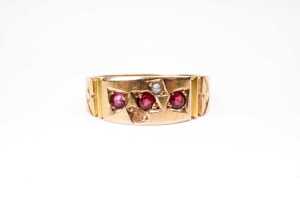An antique garnet and seed pearl ring in 15 carat yellow gold
