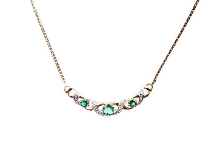 A synthetic emerald and diamond necklace in 9 carat yellow gold