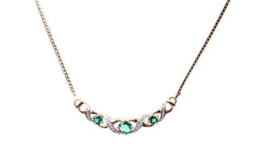 A synthetic emerald and diamond necklace in 9 carat yellow gold