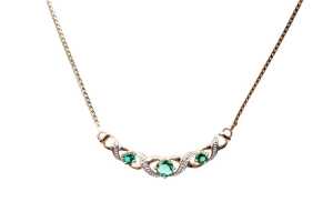 A synthetic emerald and diamond necklace in 9 carat yellow gold