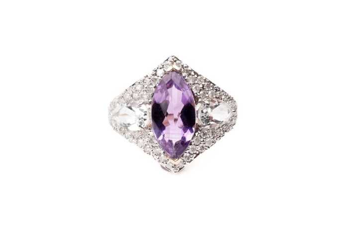 An amethyst, white topaz and diamond ring in 14 carat yellow gold