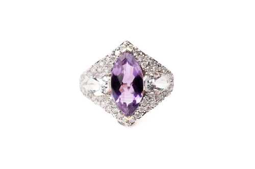 An amethyst, white topaz and diamond ring in 14 carat yellow gold