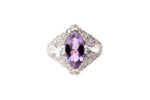 An amethyst, white topaz and diamond ring in 14 carat yellow gold