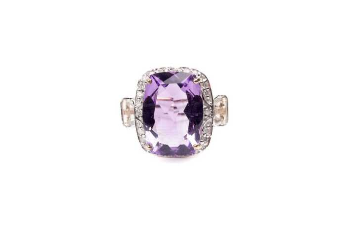 An amethyst, white topaz and diamond ring in 9 carat yellow gold