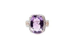 An amethyst, white topaz and diamond ring in 9 carat yellow gold