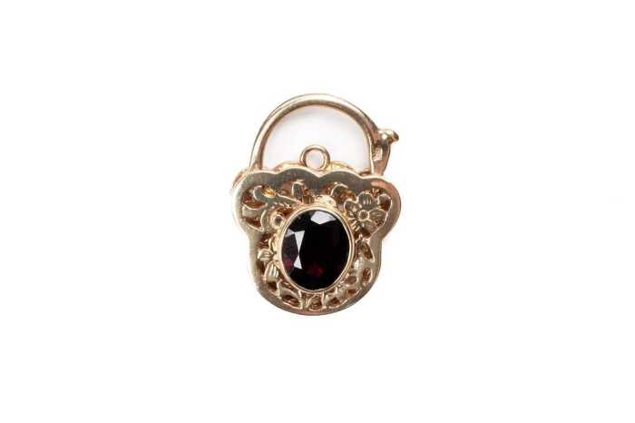 A garnet padlock in 9 carat yellow gold