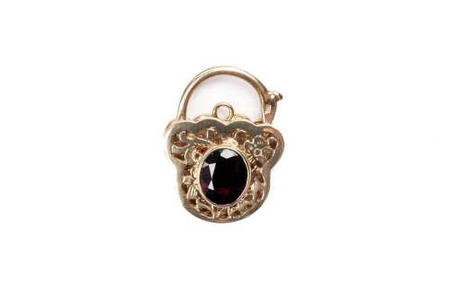 A garnet padlock in 9 carat yellow gold