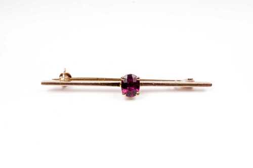 A vintage ruby bar brooch in 9 carat yellow gold
