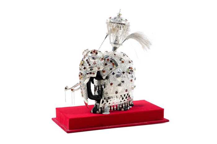 Sri Lankan elephant figure with silver overlay supporting a shrine