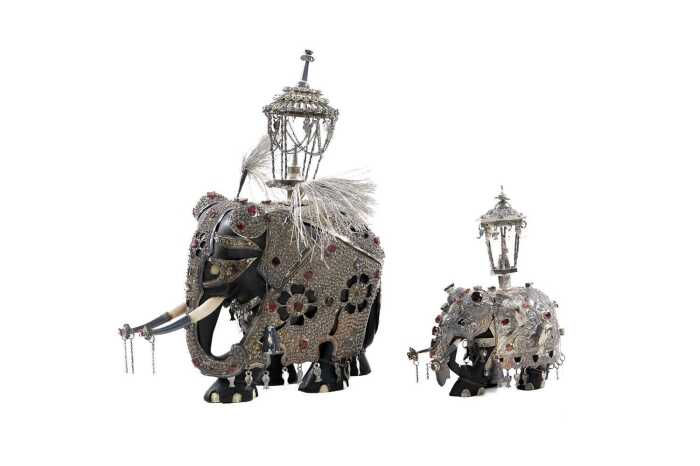 Two Sri Lankan elephant figures with silver overlay supporting shrines