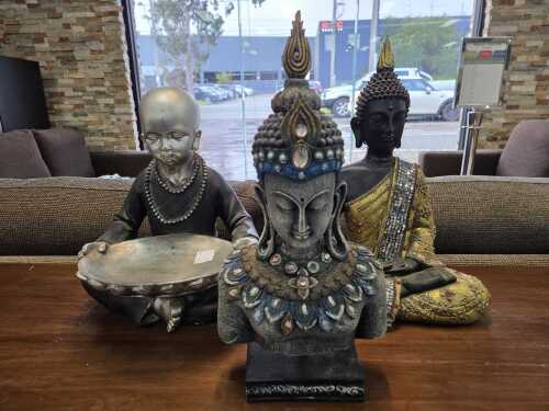 32 · Three decorative Buddha figures