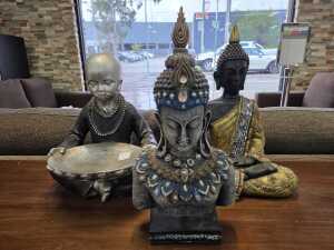 Three decorative Buddha figures