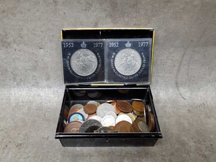 Assorted world coins in Chad Valley moneybox