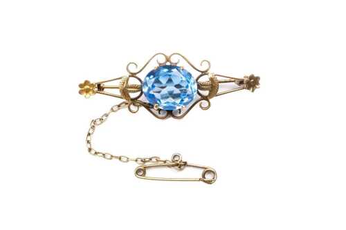 An antique blue paste brooch in 9 carat yellow gold