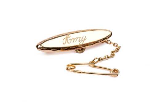 An ID brooch in 9 carat yellow gold