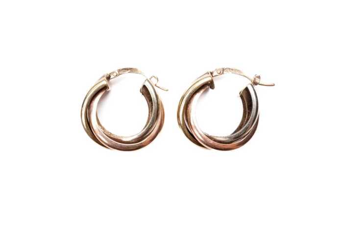 A pair of triple hoops in 9 carat three tone gold
