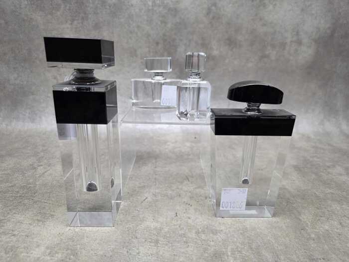 Four glass perfume bottles with applicators