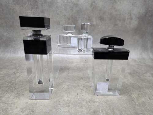 Four glass perfume bottles with applicators