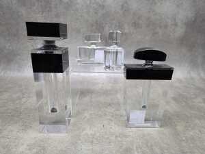 Four glass perfume bottles with applicators