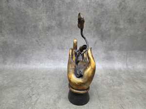 Cast metal sculpture of Buddha hand holding a lotus flower - 2