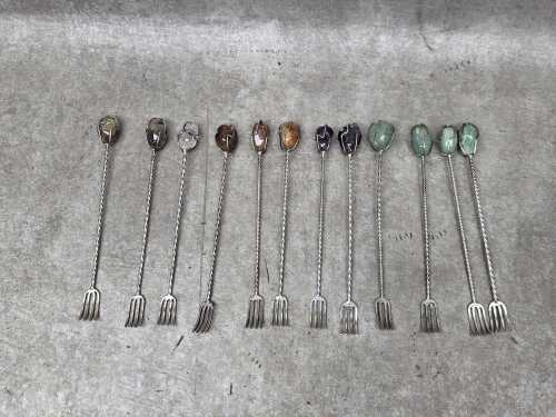 Twelve silver-plated pickle forks mounted with semi-precious stones