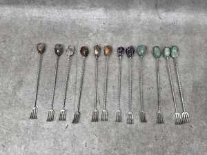 Twelve silver-plated pickle forks mounted with semi-precious stones