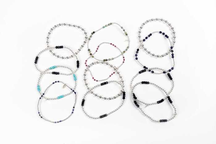 A collection of twelve bracelets in sterling silver