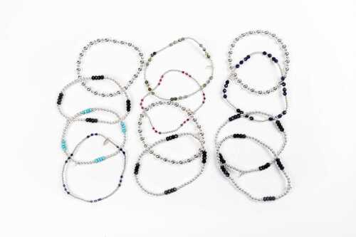 A collection of twelve bracelets in sterling silver