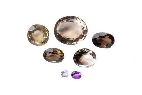 A collection of smoky quartz, blue topaz and amethyst