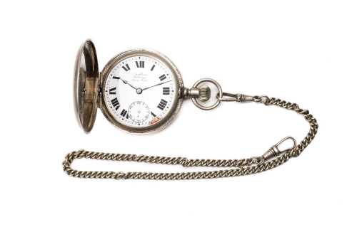 An antique watch and chain in silver tone metal