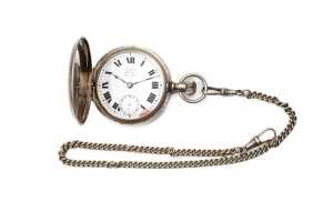 An antique watch and chain in silver tone metal