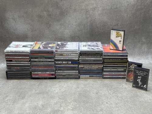 CDs together with three cassettes, including Queen and The Beatles