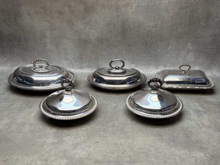 Five stainless steel lidded serving ware