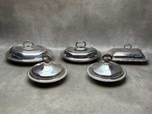 Five stainless steel lidded serving ware