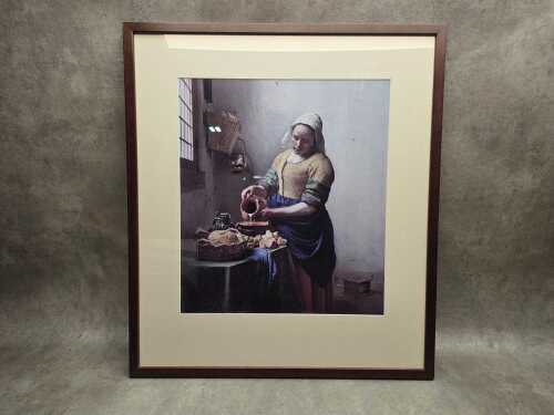 After Johannes Vermeer, The Milkmaid. Framed reproduction print on paper