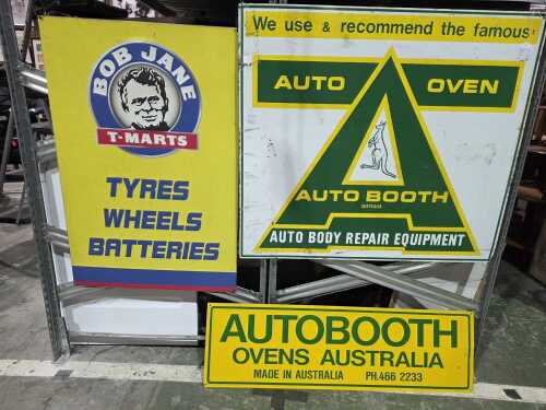 Three metal automotive advertising signs