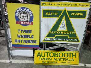 Three metal automotive advertising signs