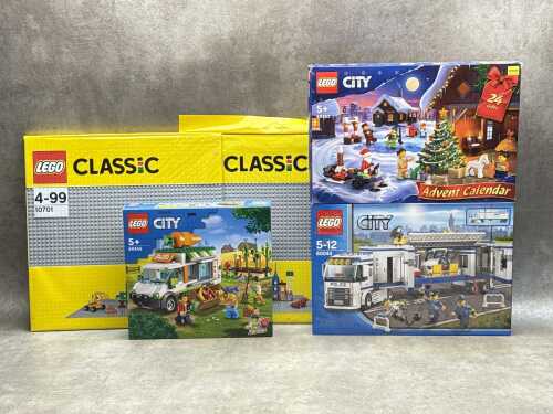 Three LEGO City playsets and a base plate
