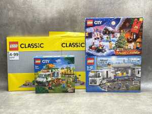 Three LEGO City playsets and a base plate