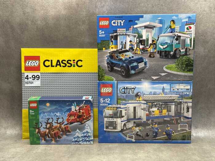 Three LEGO City playsets and a base plate