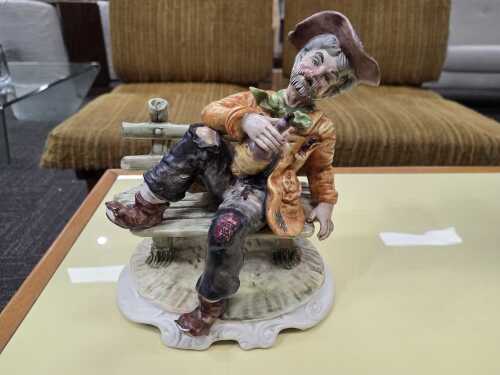 Capodimonte tramp on a bench ceramic figure