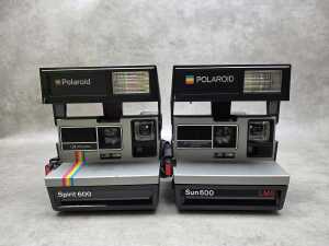 Two Polaroid instant cameras