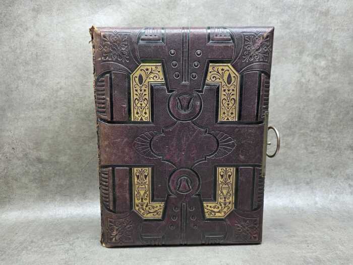 Antique leather-bound photo album with a brass clasp